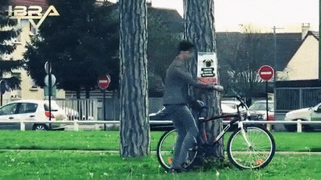 Cyclist trying to cut the tree with rope