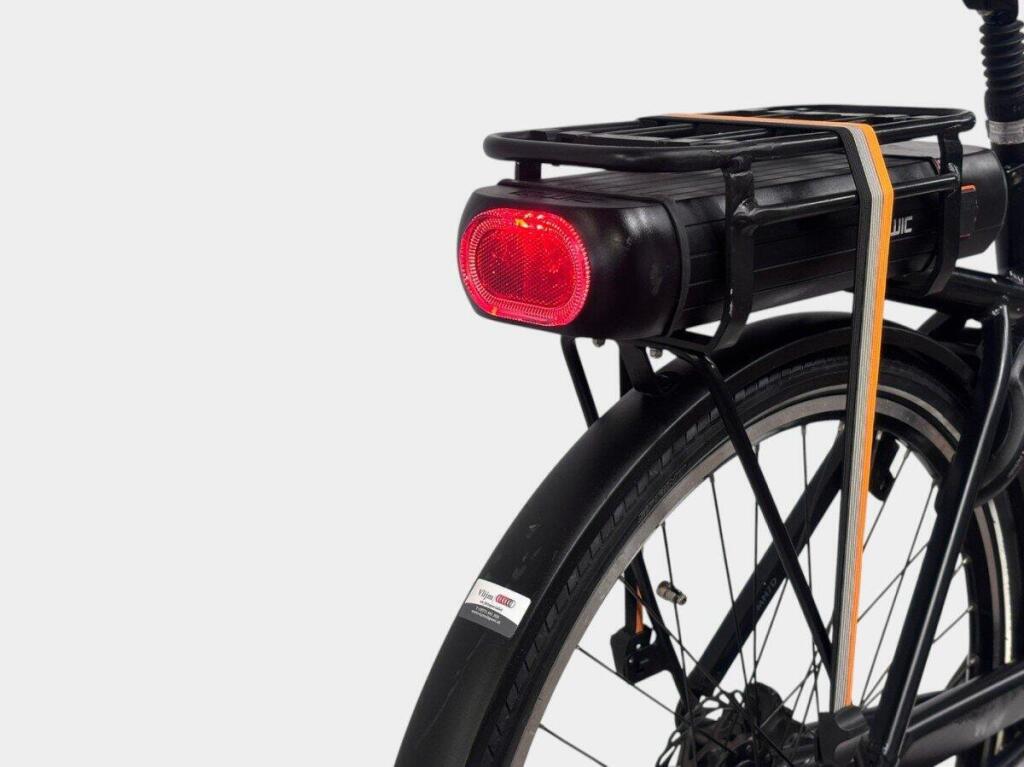 The battery in the rear rack of a Qwic Premium MN7D, with the rear light built into it