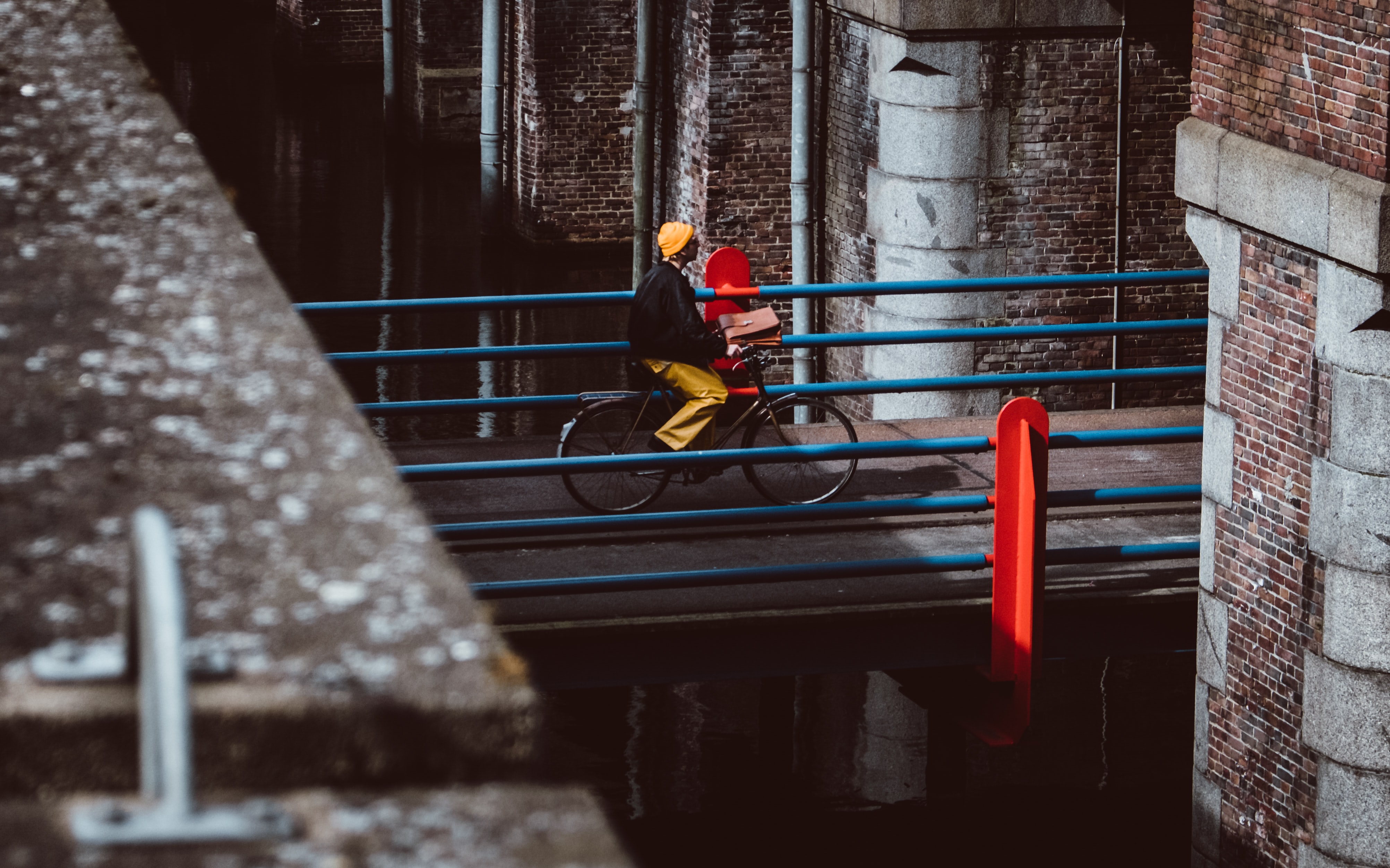 Man riding city bike over the bridge