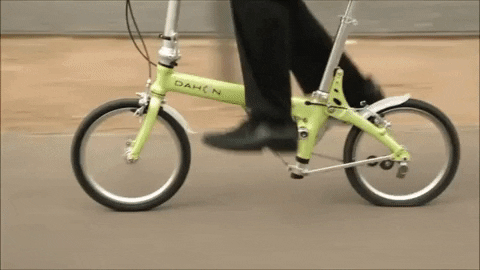 Green folding bike ride through the city