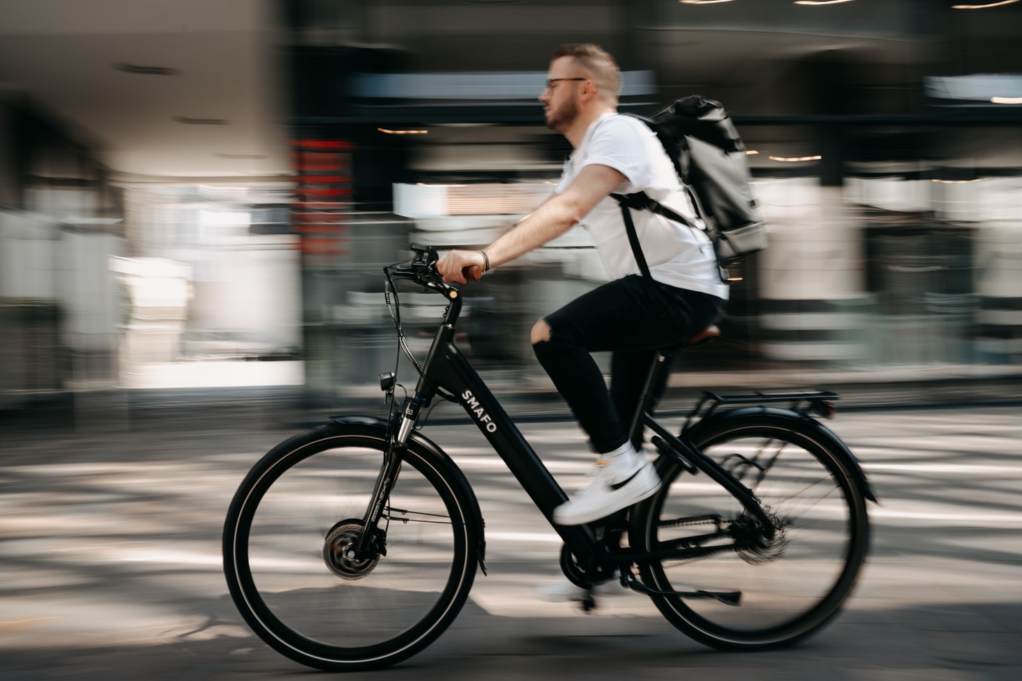 Man riding new black e-bike in the city